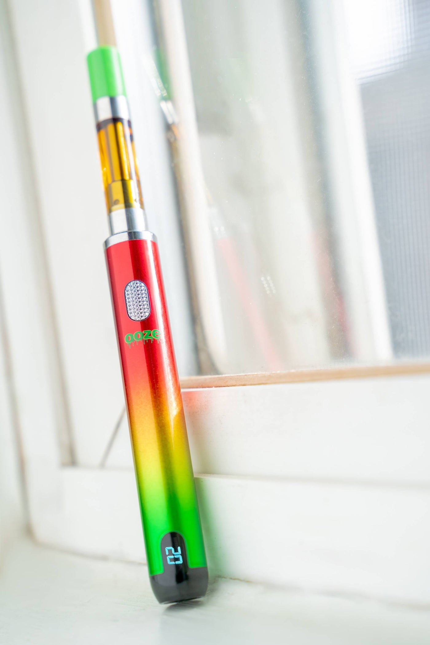 A Rasta Smart battery leaning against a window with the screen on
