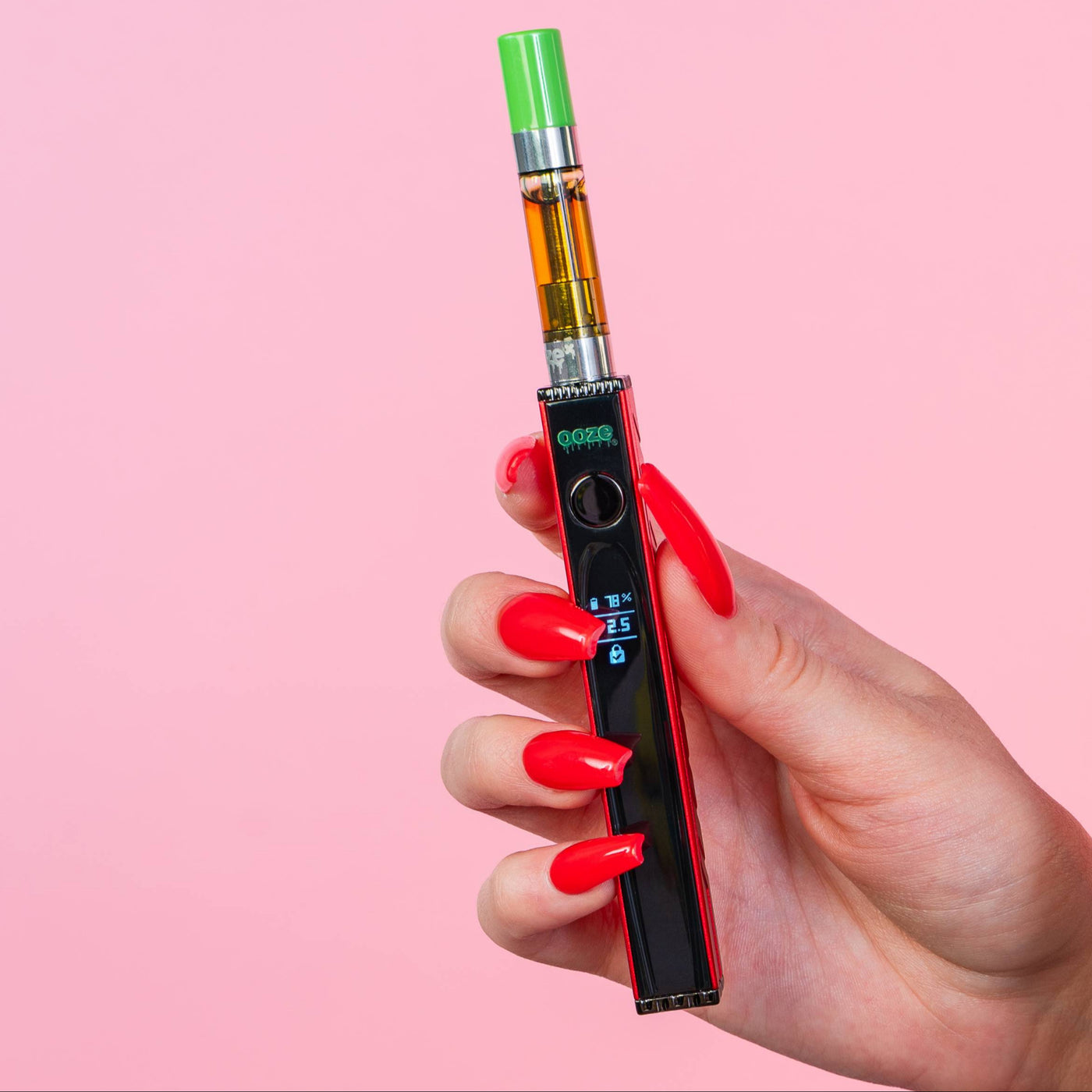 Holding a ruby red Quad 2 battery with a green-tipped cart