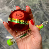 Holding a red saturn grinder with a rasta glass blunt slider