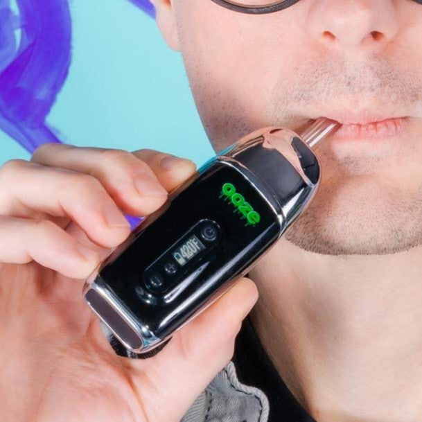 Person using a chrome Ooze Flare dry herb vape