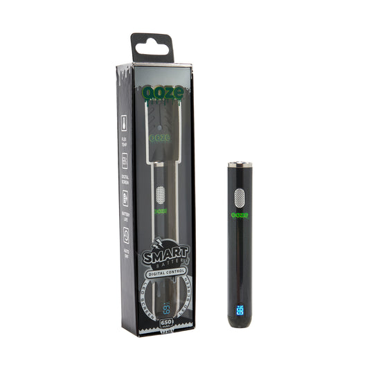 The black Ooze Smart Battery is upright and turned on, next to the package