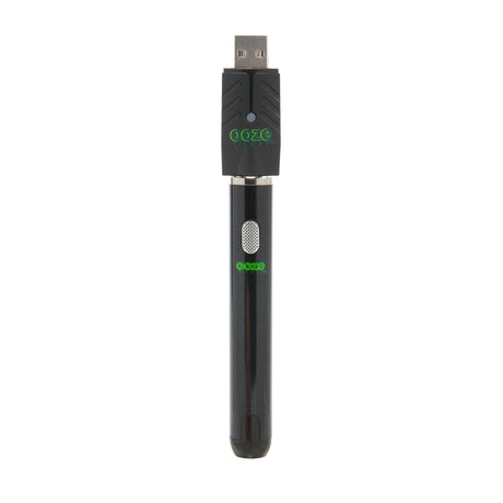 The black Ooze Smart Battery is upright with the charger attached