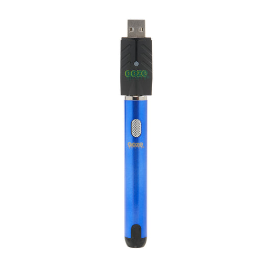 The sapphire blue Ooze Smart Battery is upright and shut off with the charger attached