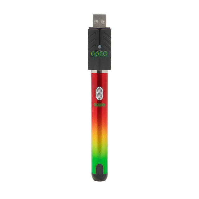 The rasta Ooze Smart Battery is upright with the charger attached