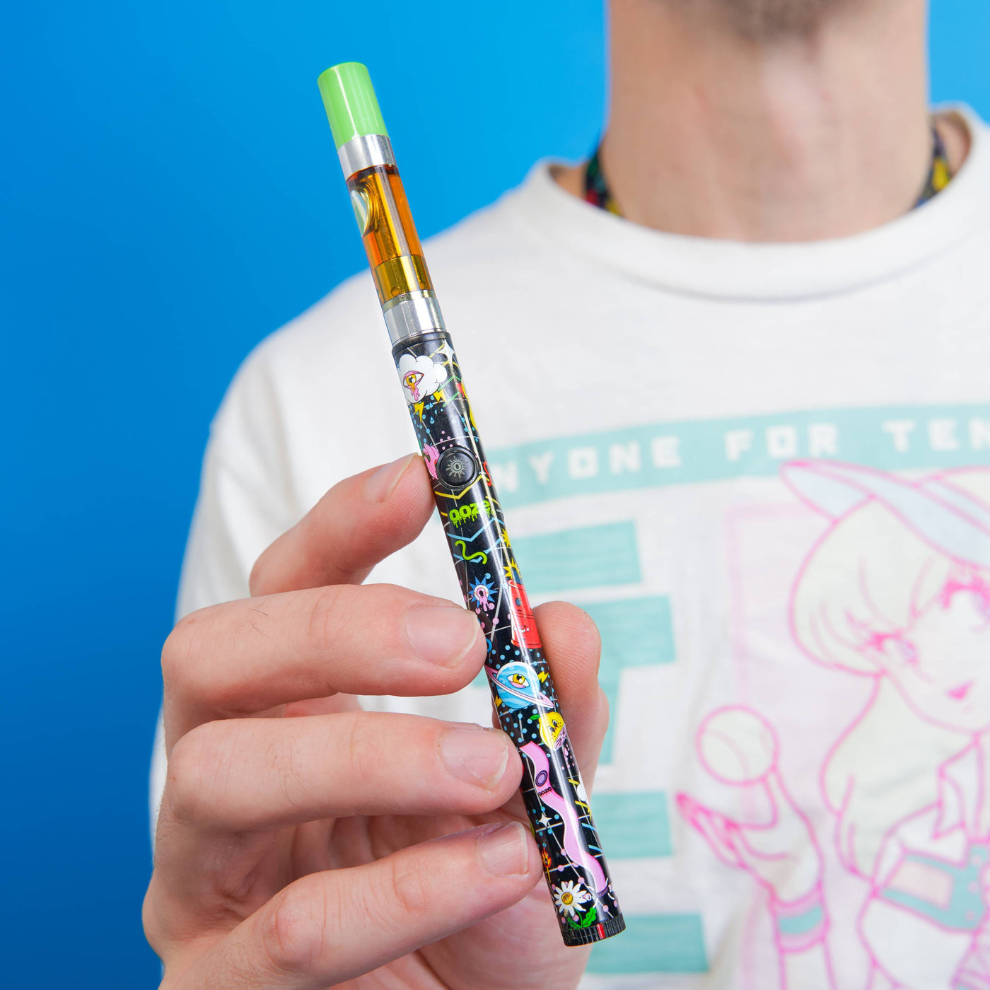 Holding up a Time Warp design Twist Slim Pen 2.0 with a green-tipped cartridge