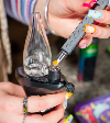 Loading a dab into a black Trigger e-rig with a hot knife