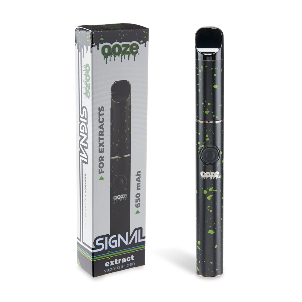 The Green Splatter Ooze Signal wax pen is shown standing next to its original packaging in front of a white background.