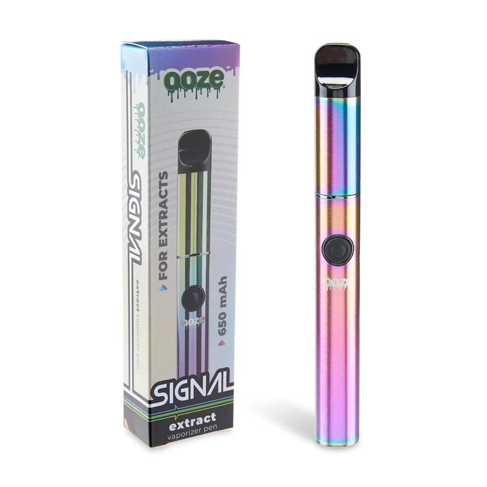 The Rainbow Ooze Signal wax pen is shown standing upright next to its original packaging against a white background.
