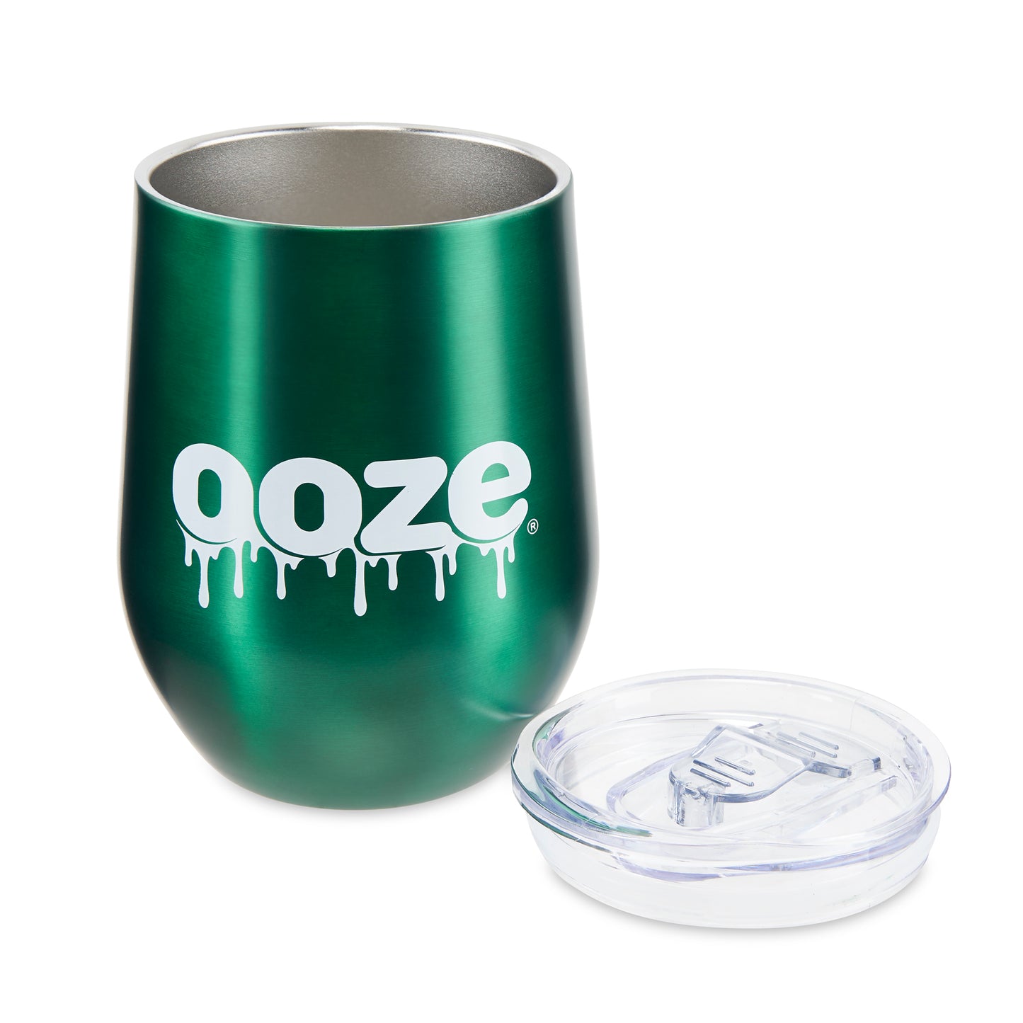 The green Ooze Tumbler is sitting upright with the plastic cap removed and sitting to the right of the cup.