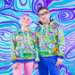 A white girl with a short purple wig and a white guy with chunky square glasses are side by side in matching Chroma hoodies.