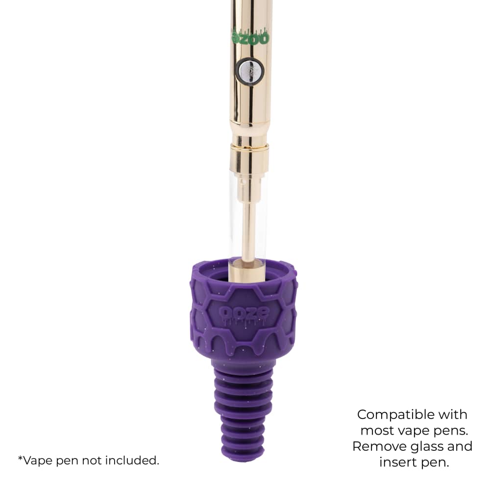 A gold Ooze pen is flipped upside and inserted into a purple armor bowl to demonstrate the vape adapter function