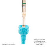 The aqua teal Ooze UFO's silicone armor bowl is shown with a gold vape pen inserted into it to show the vape adapter function