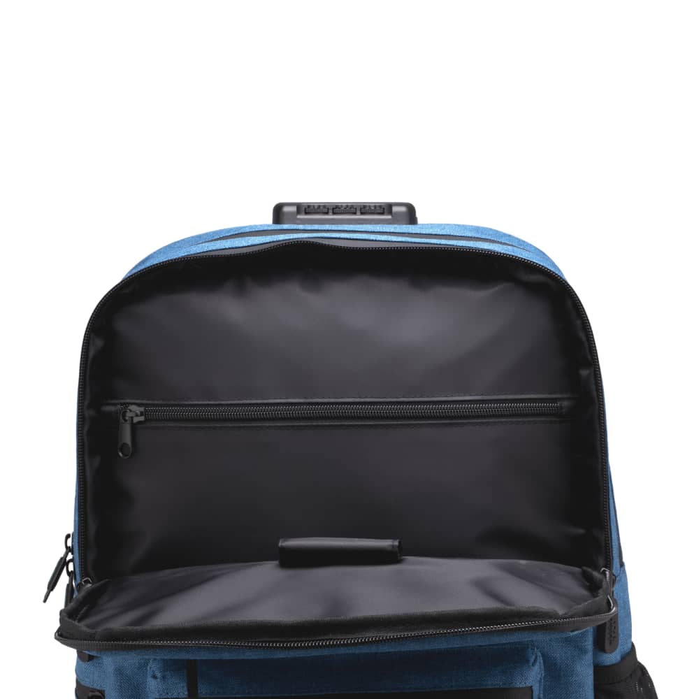 The top of the surf blue Ooze backpack is unzipped to show the black lining