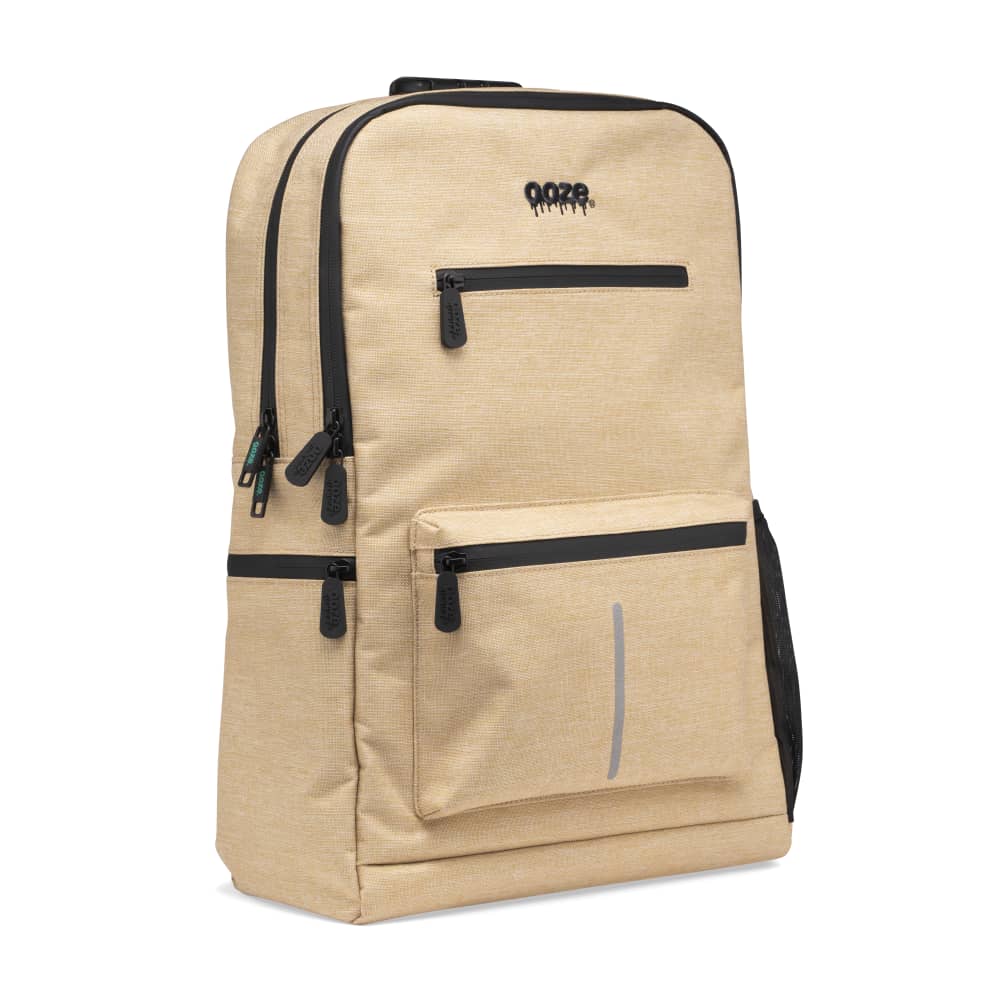 The desert sand Ooze backpack is zipped up on an angle