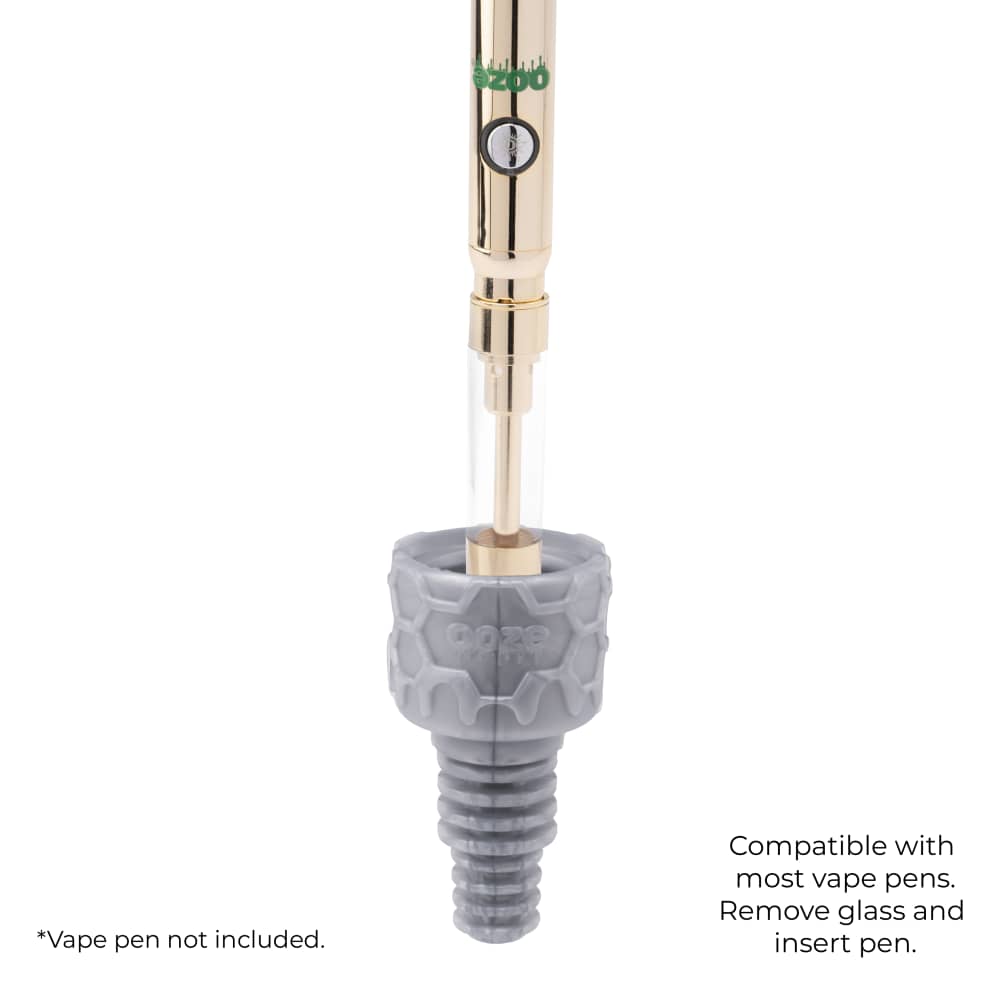 A gold Ooze pen is turned upside down and inserted into a silver armor bowl to demonstrate the vape adapter function